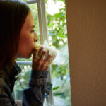 Woman smoking sploof out window