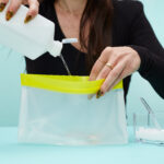 Woman pouring salt and alcohol into ziploc bag