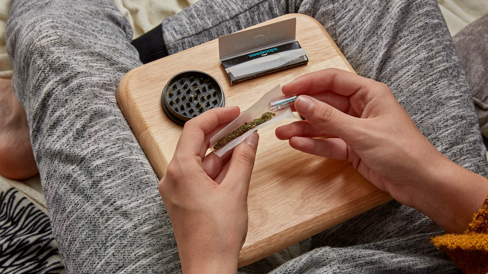 Hands rolling joint