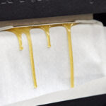 Rosin being made in a press.