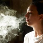 woman exhaling marijuana smoke