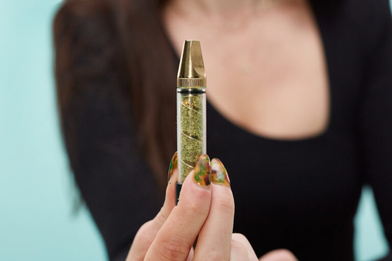 Click to see a larger version of the image Closeup of hand holding a glass blunt.