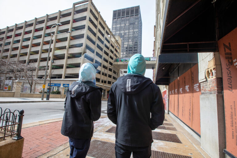 Click to see a larger version of the image Two people walking in a city