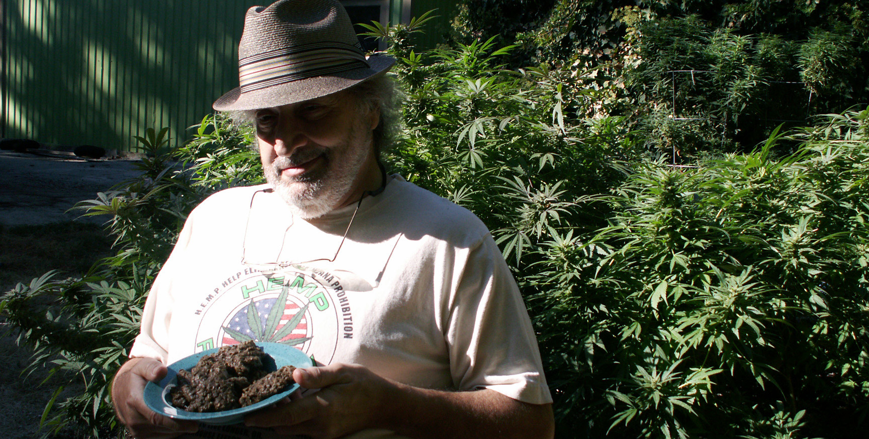 Jack Herer holding a plate of homemade cannabis cookies in his garden