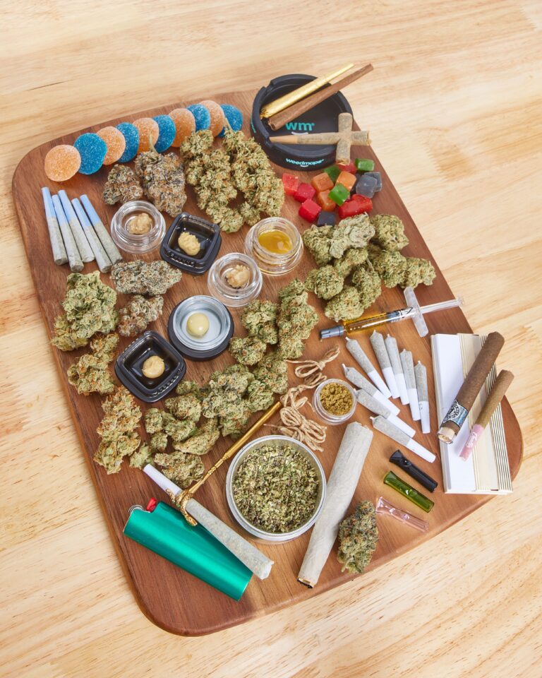 Blunt, Concentrate, Distillate Syringe, Edible, Gummies, Infused Flower, Nug, Preroll, Shake on a wooden charcuterie tray