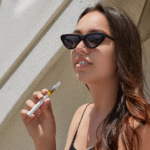 Young woman using a cannabis vape pen