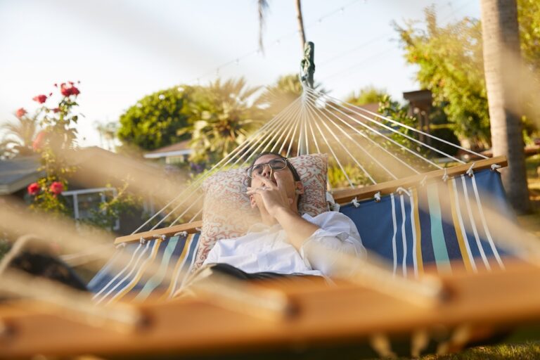 man in hammock smoking joint