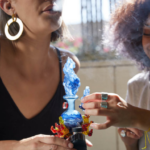 Two ladies dabbing concentrate