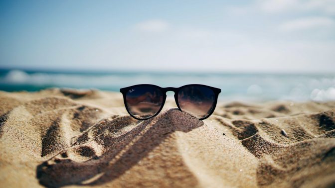 sunglasses in the sand on the beach