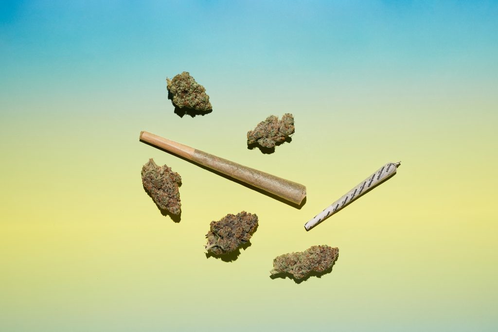 two joints and 5 nugs on a yellow and blue background.