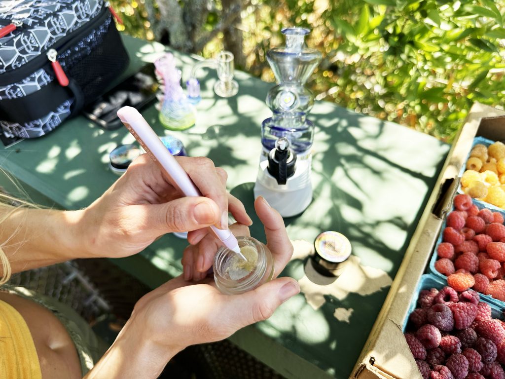 Loading up hash on a pen next to a carton of berries for a hash and berry pairing.