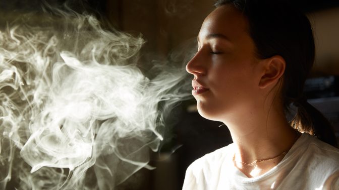 woman exhaling cannabis smoke